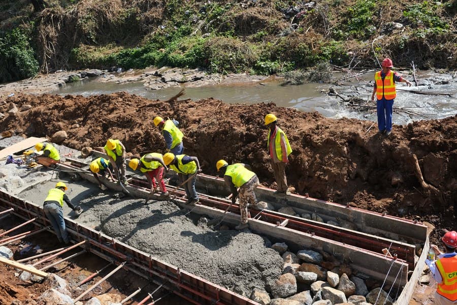 Ethiopian infrastructure crew pouring a concrete foundation